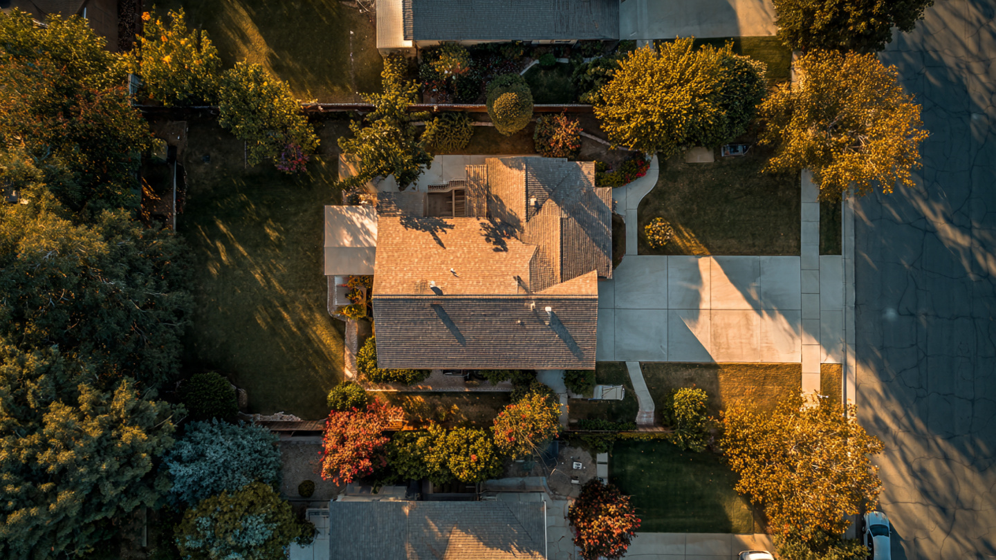 Satellite view of residential neighborhood with AI property scoring overlays